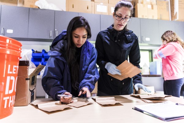Two students logging material in a lab