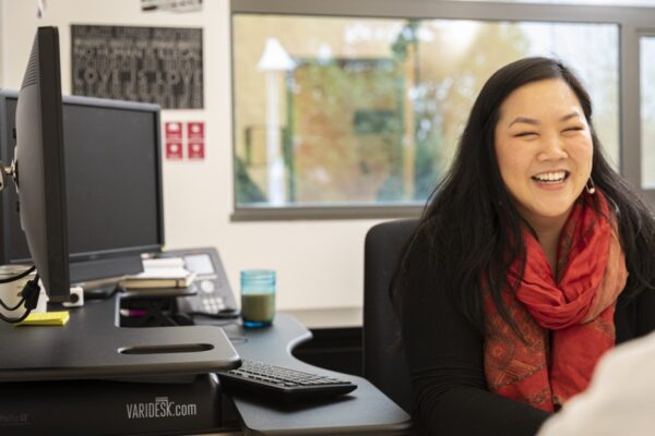 counselor smiling while meeting a student in an office