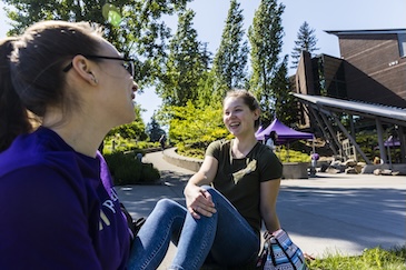 Two people sitting on the ground.