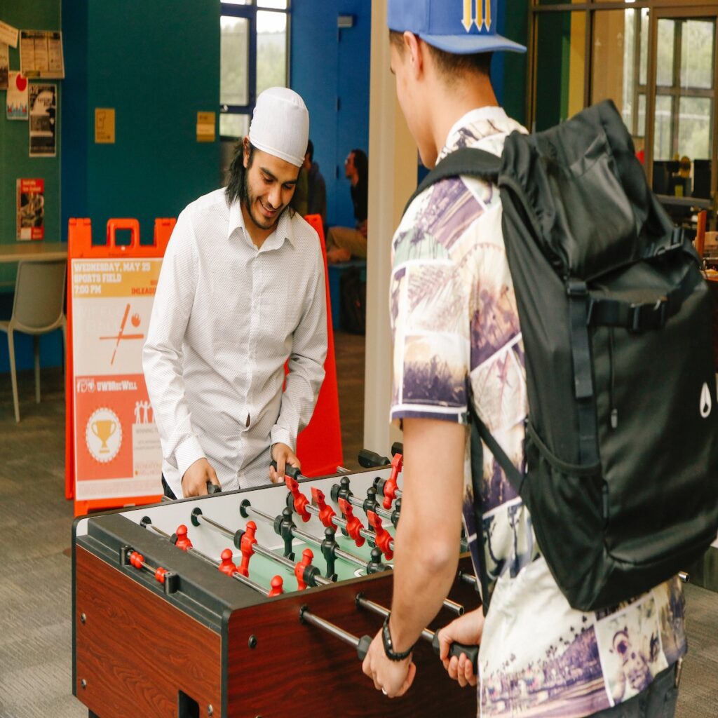 Two people playing foosball.