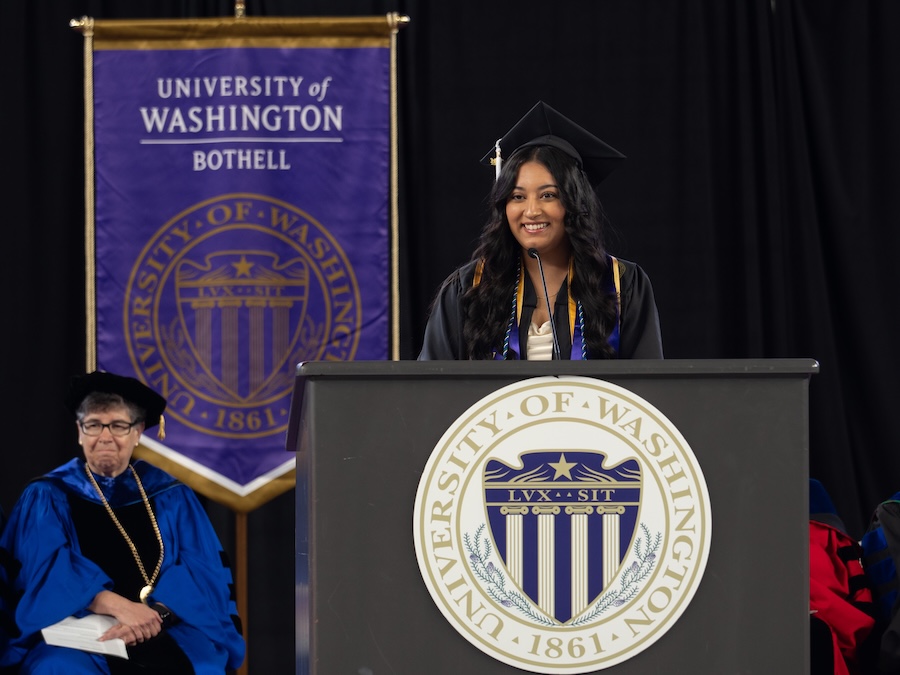Student speaking at podium at graduation.