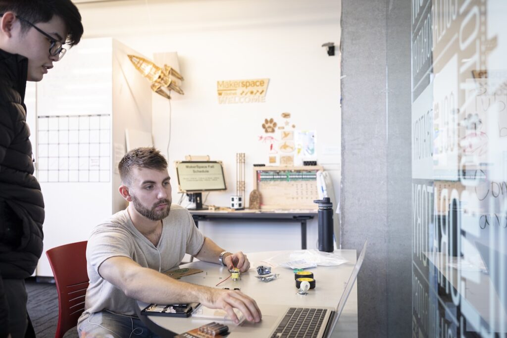 Two people working together at the Makerspace.