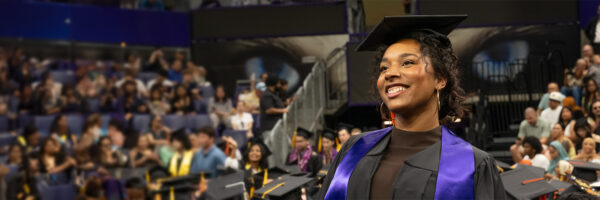 A graduate stands during UW Bothell's 34th commencement. 