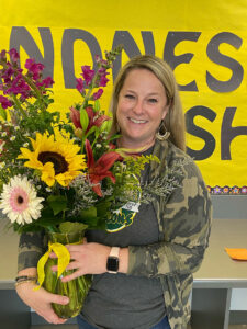 Melanie is holding a large bouquet.