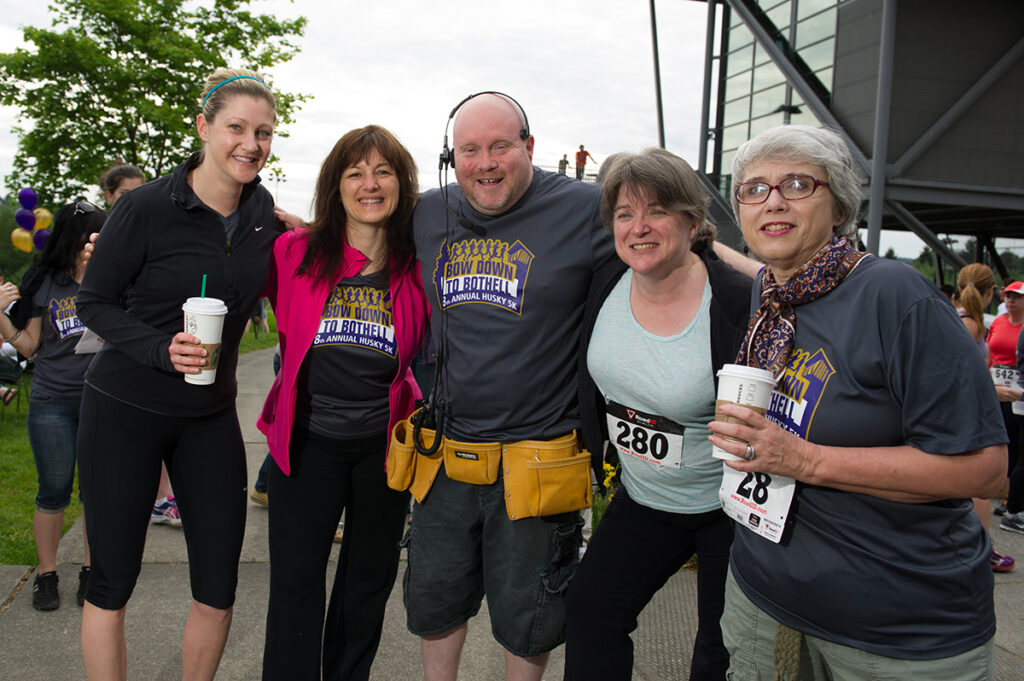 Group photo of 5 people with Sean Marsh in the middle. People are wearing UW Bothell 5k shirts and running numbers.