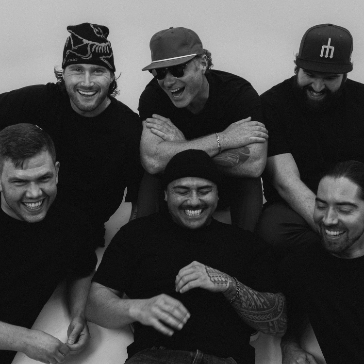 Black and white photo of 5 members of the musical group Swavy, laughing