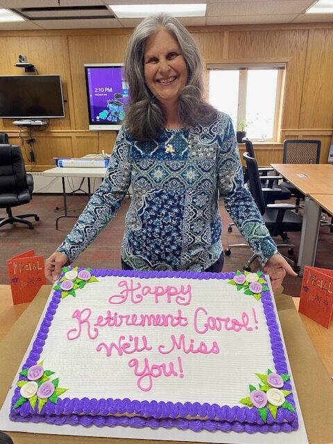 Carol Shipe with a cake at her retirement