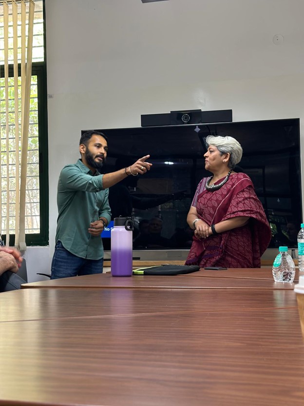 A man and a woman discussing something in a conference room