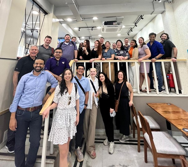 faculty and student posing for photo on stairs