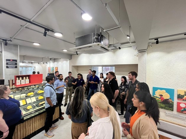 Students listen to a speaker at the tea factory