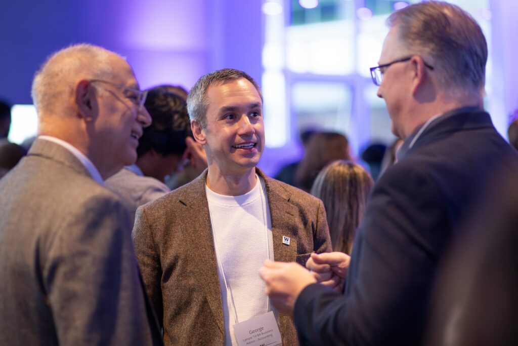 Three people conversing at the event