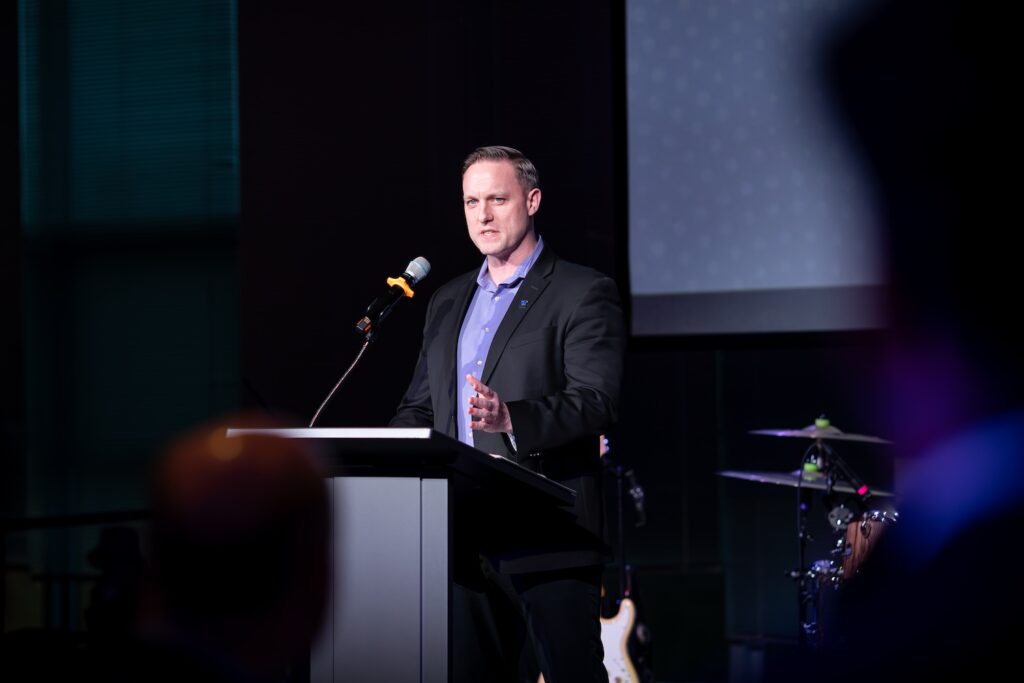 Ben Studley speaking at a podium
