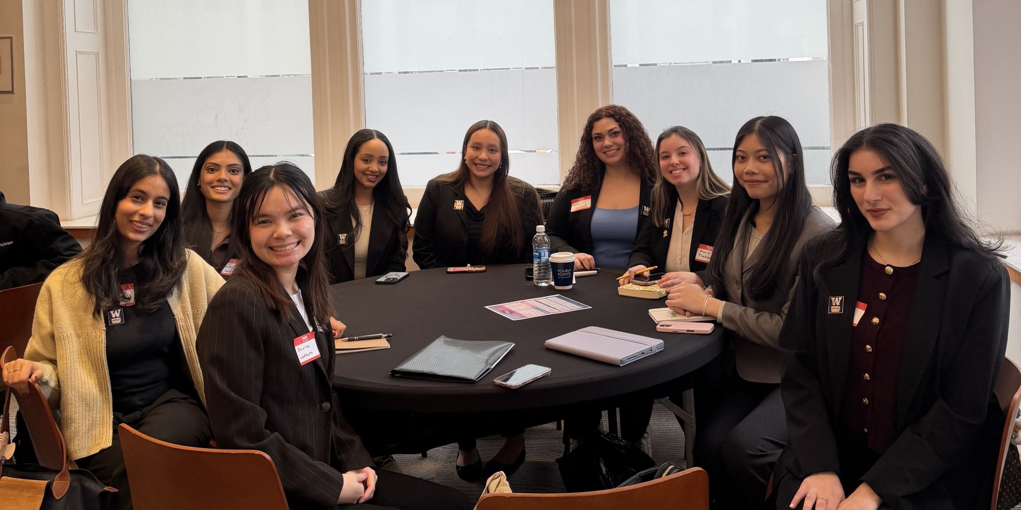 UW Bothell WIB students sitting at a conference table.