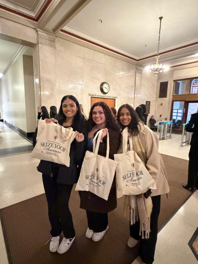 UW Bothell WIB students posing with Seize Your Success tote bags from the conference.