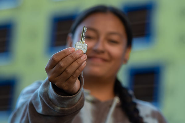 Student holding up a key to their residential dormitory