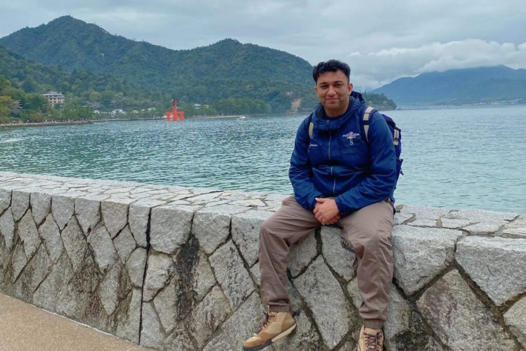 Kanu sitting on the stone wall alongside Hiroshima Bay in Japan.