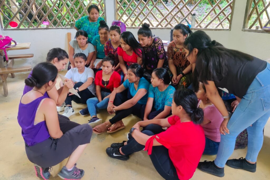 Nursing students Rachelle Mahoney (left) and Leylani Blanco (right) teach sex education to a group of female students at the Ak’ Tenamit boarding school, located on the Tatín River and accessible only by boat.