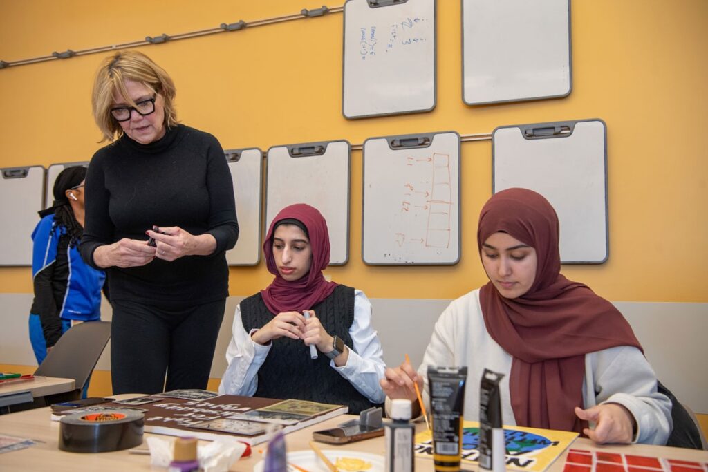 Dr. Maureen West takes a look at her students' artwork in her class, "Disability Representation in Society."