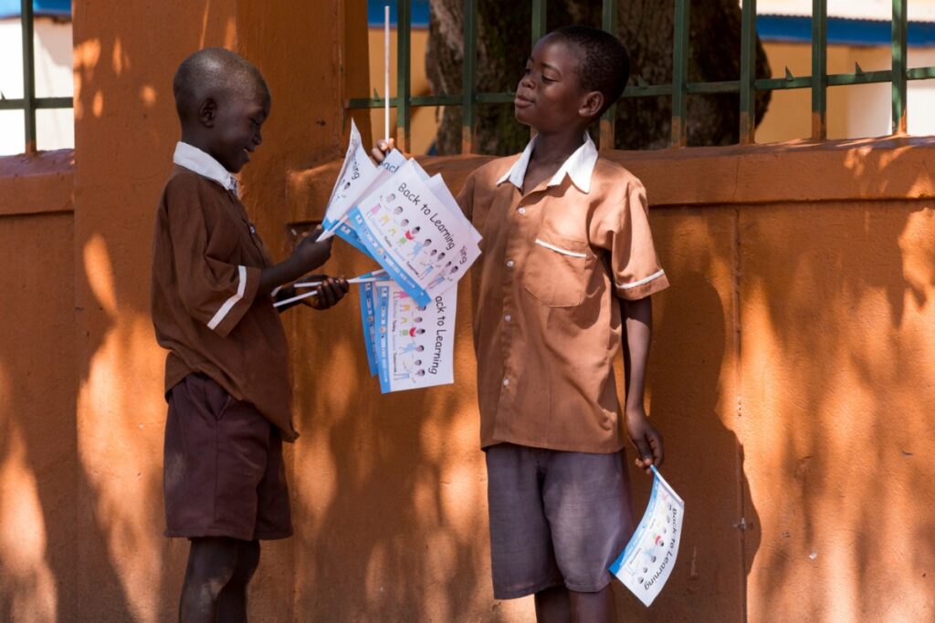two little boys exchanging flags