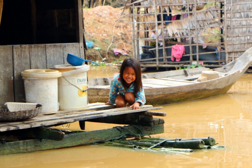 a little girl smiling at the photographer