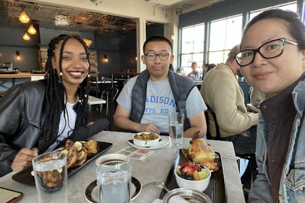 student meets with intern mentors over breakfast