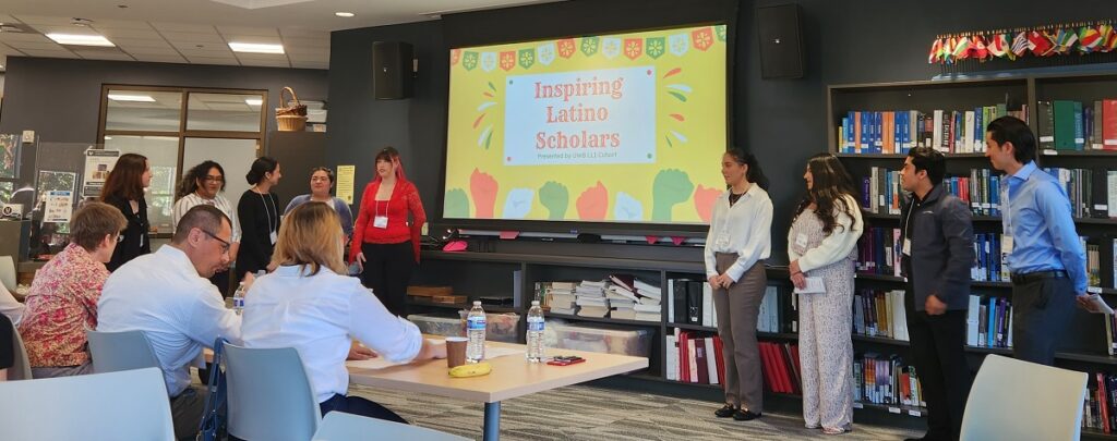 Students in class look at presentatation slide that reads "inspiring Latino students"