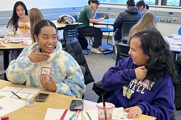 Students smiling and laughing with each other during networking activity