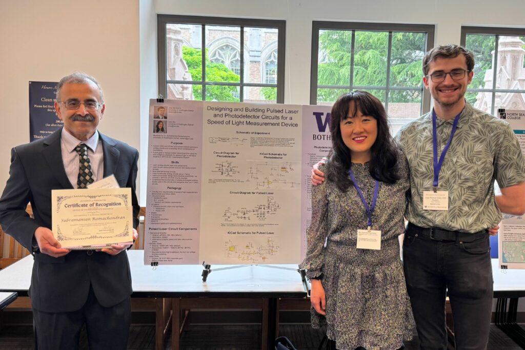 three people stand in front of their poster