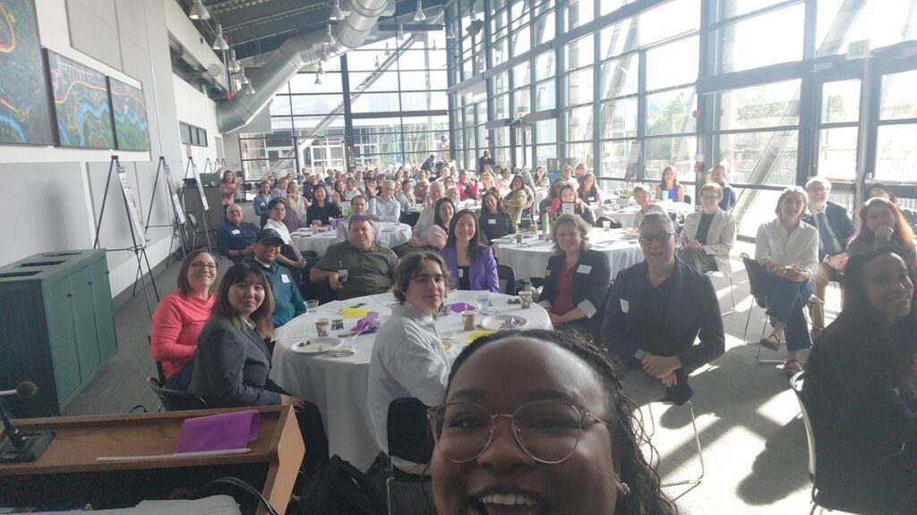 Selfie of host taking picture of the whole breakfast (100+ people) from the perspective of the stage.