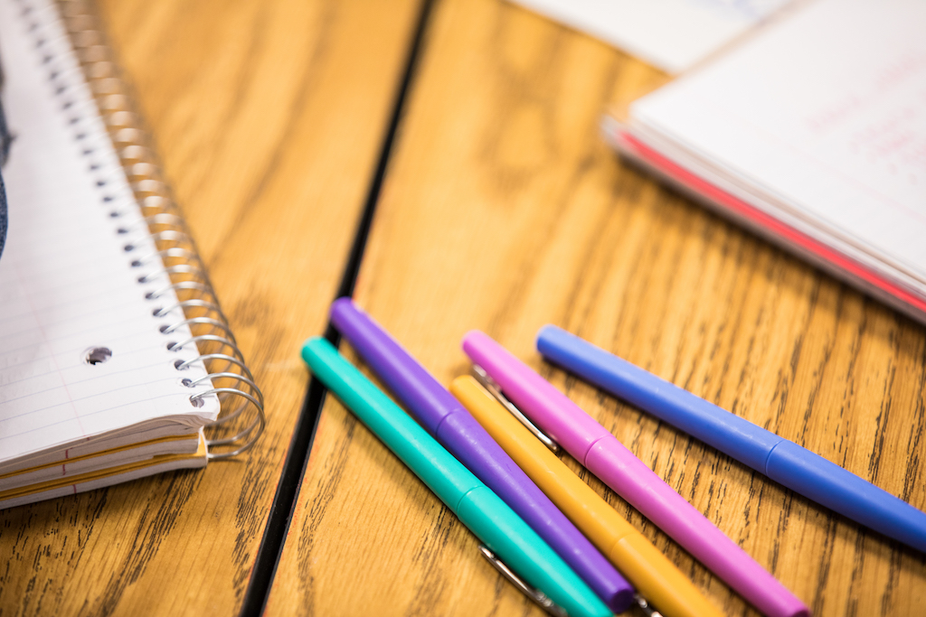 Desk with pens and notebooks