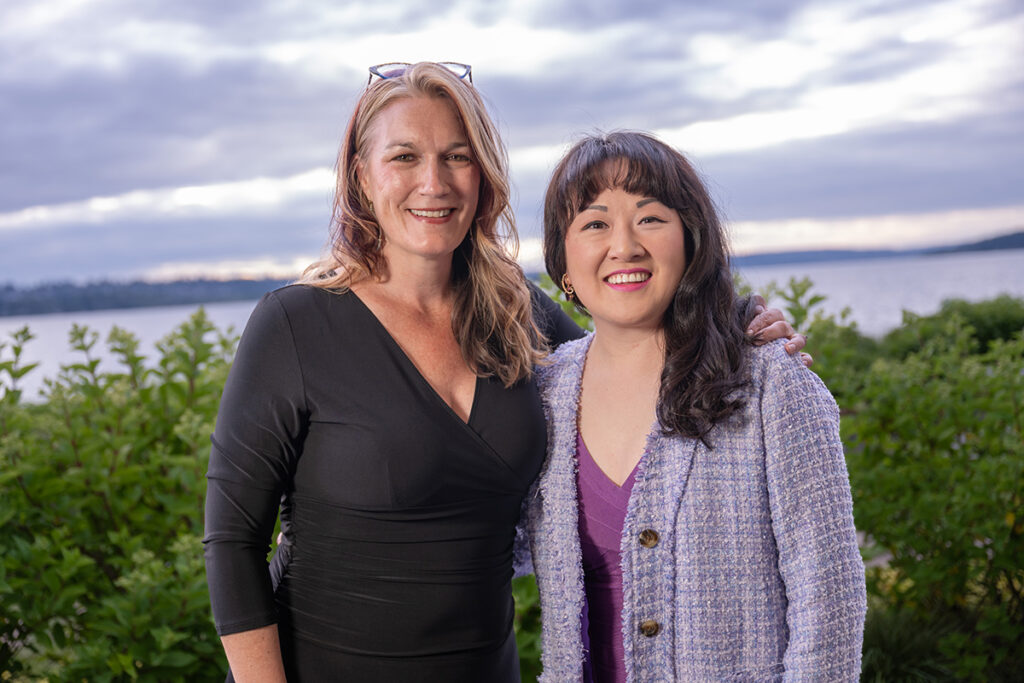 Dr. Jennifer-Mcloud and Carol Miu pose in front of a sunset.