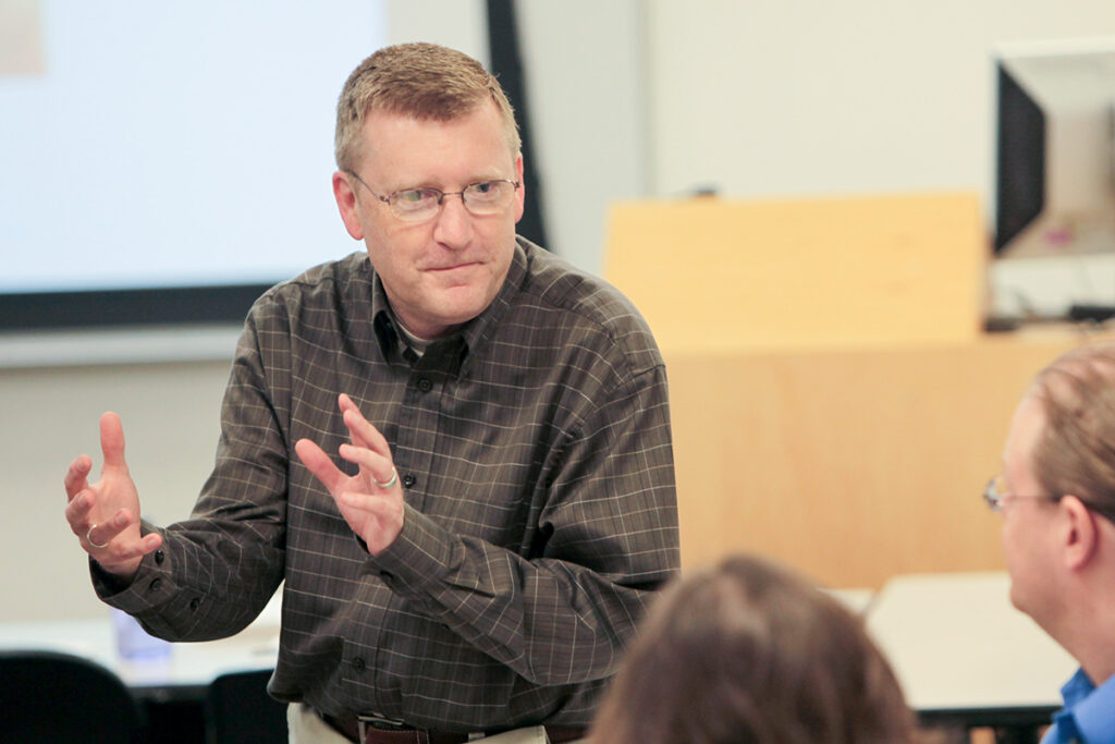 Bradley Portin speaking with students in a classroom setting.