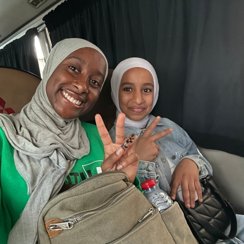 Aminah with a young refugee