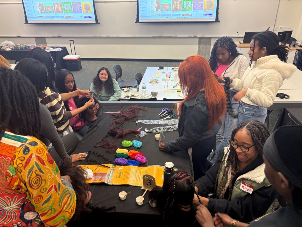 Hicks showing other students how to braid hair