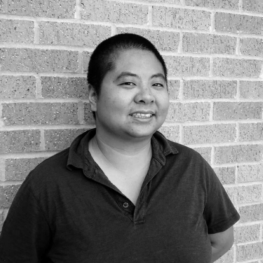 Professor Ching-In Chen. Image is in black and white, they are in front of a brick wall.