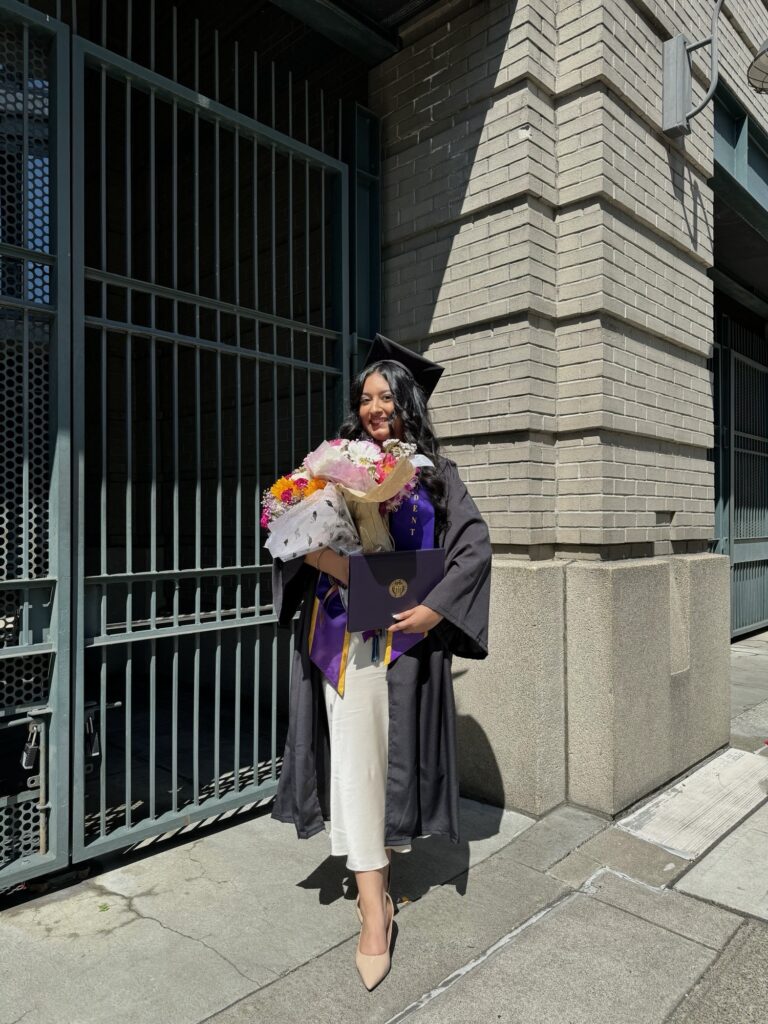 Puneet Birk smiles in her graduation gown