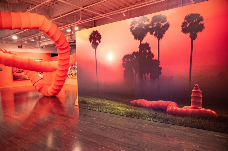 Exhibition view of Anida Yoeu Ali: The Buddhist Bug at the Vincent Price Art Museum, with Ali wearing her "bug" costume,