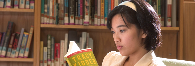 A girl is reading a book.