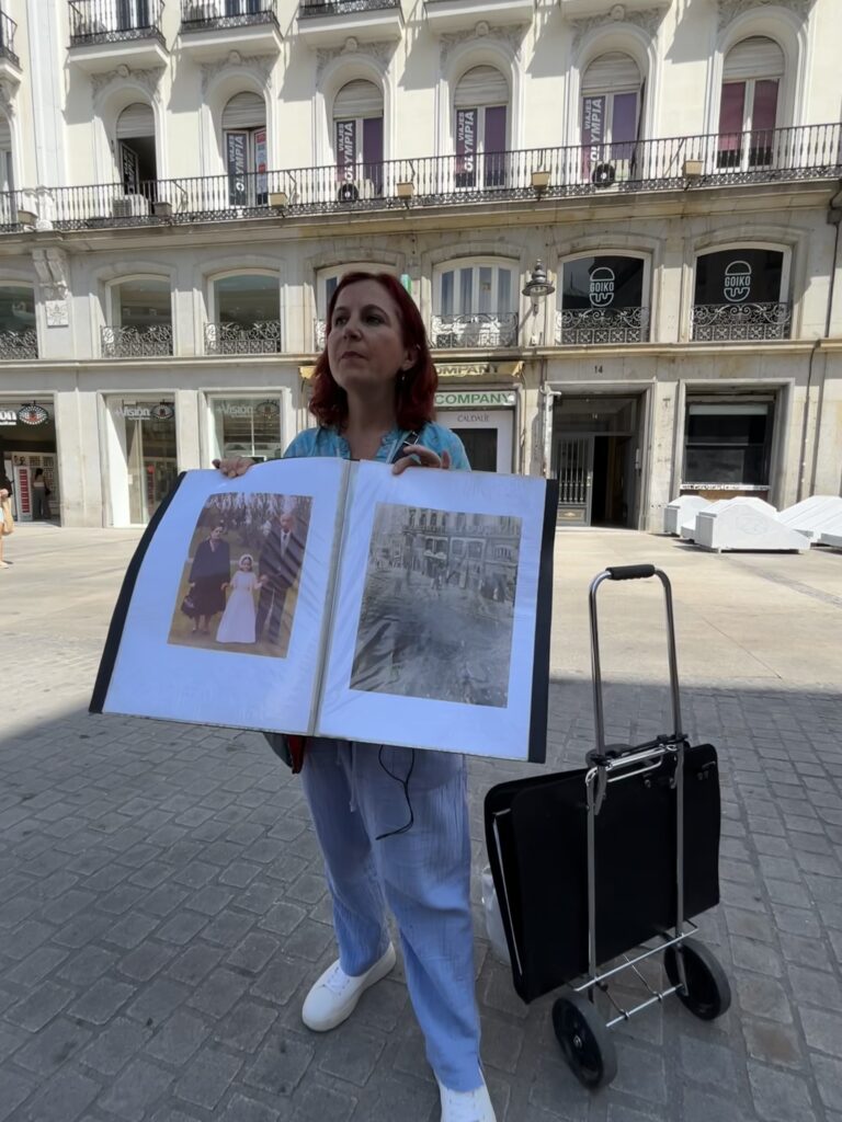 A person holding up a large book of photos.