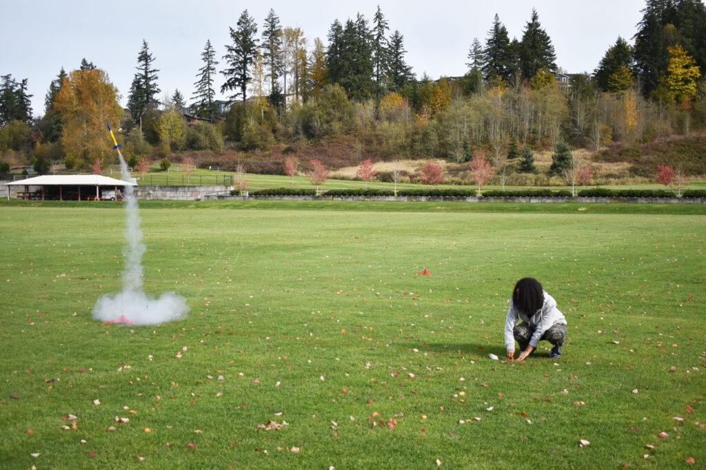 A person launching a model rocket.