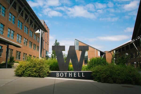 A large "W" sign on a college campus.