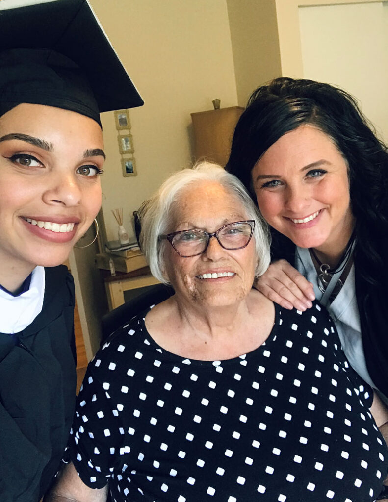 Three people take a photo together.