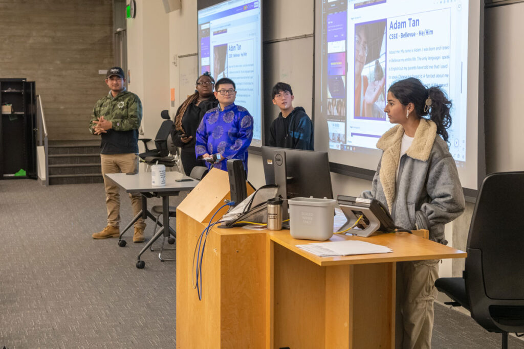 A group of people presenting to a classroom.