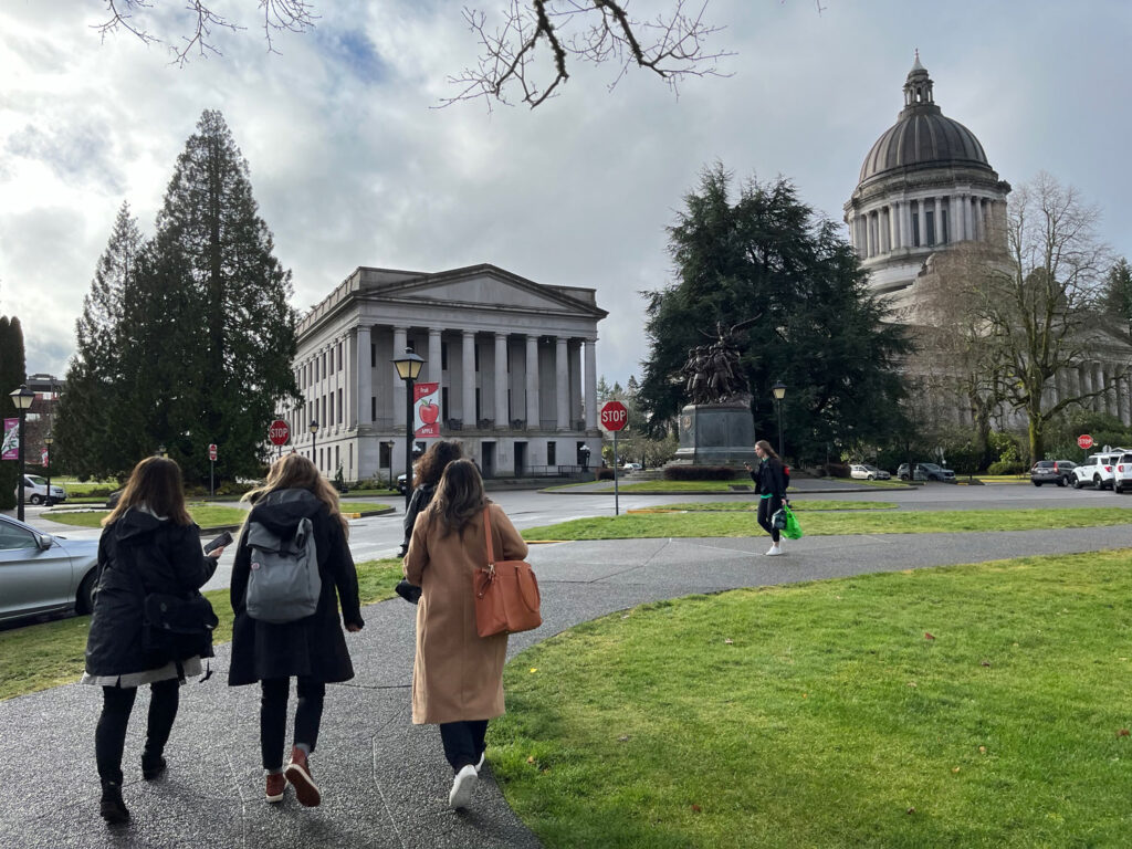 People walking toward a building.