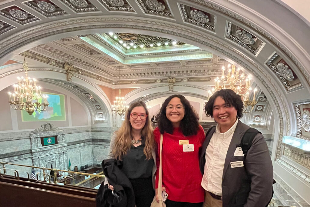 Three people pose for a photo.