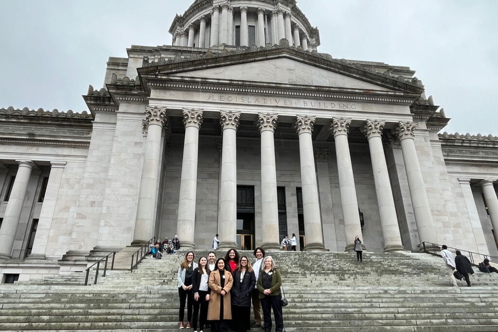 A group of people in front of a building.