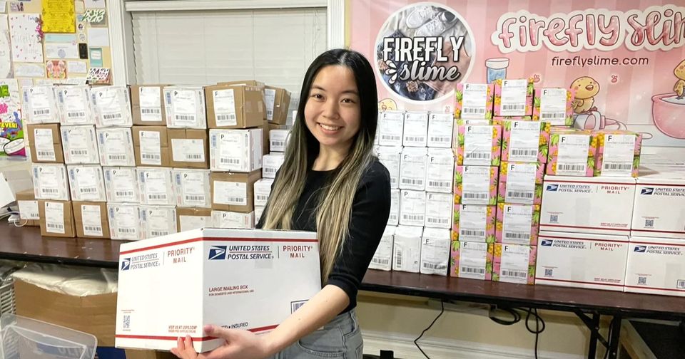 A person holding a shipping box.