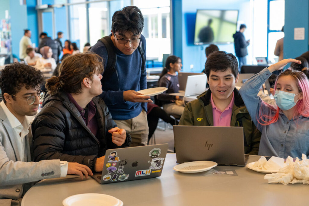 A group of people look at computers.