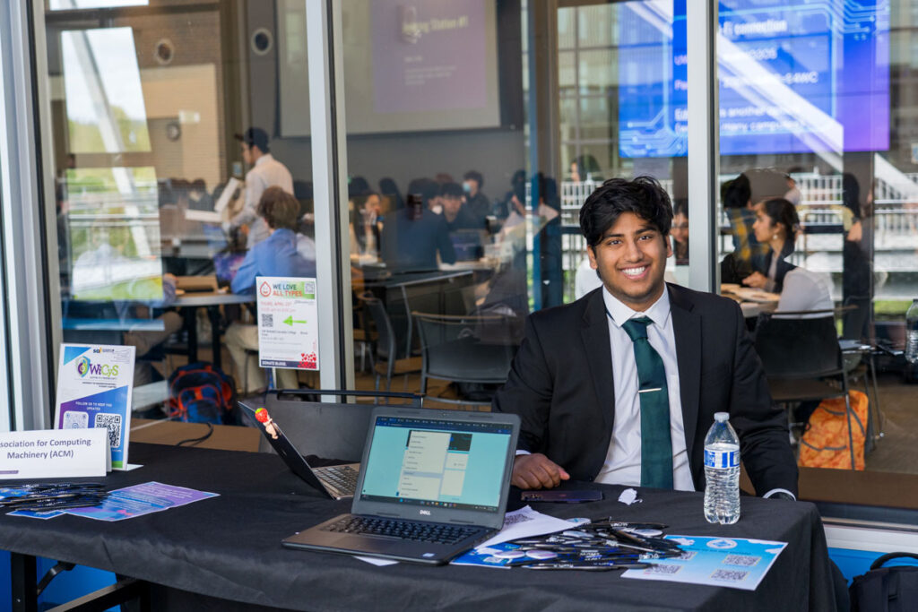 A person at a table with a computer.