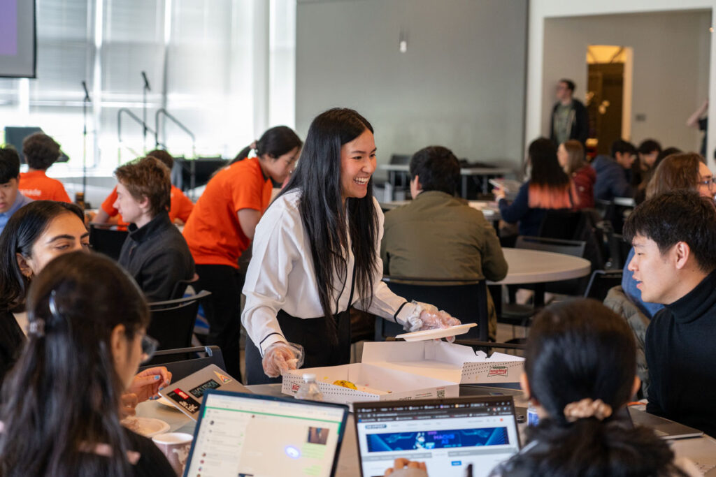 A group of people with computers at a table.